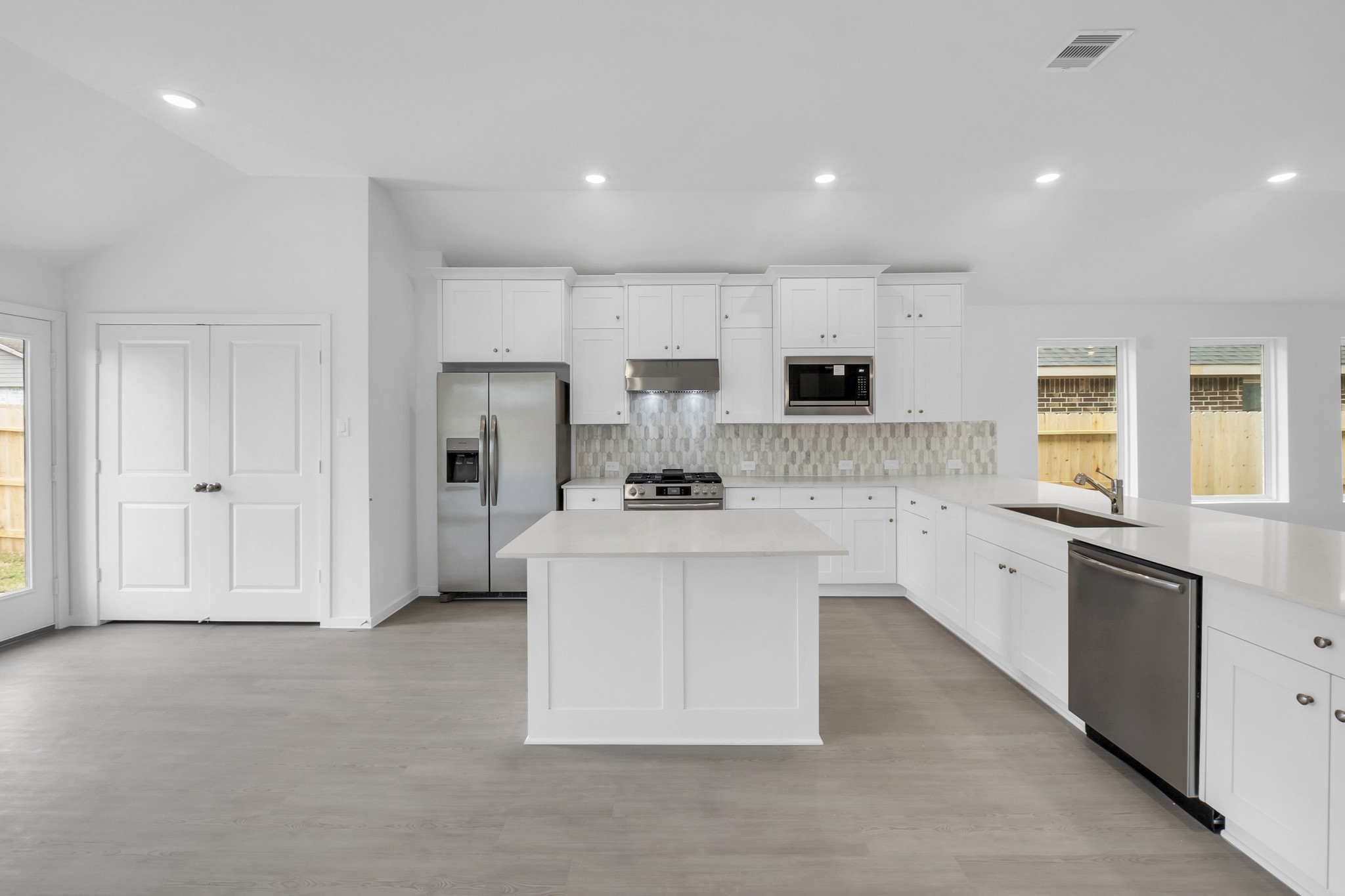 2131 Mosaic Vly Court Angleton, TX 77515 - Photo 7 of 29 a view of kitchen with sink microwave and refrigerator
