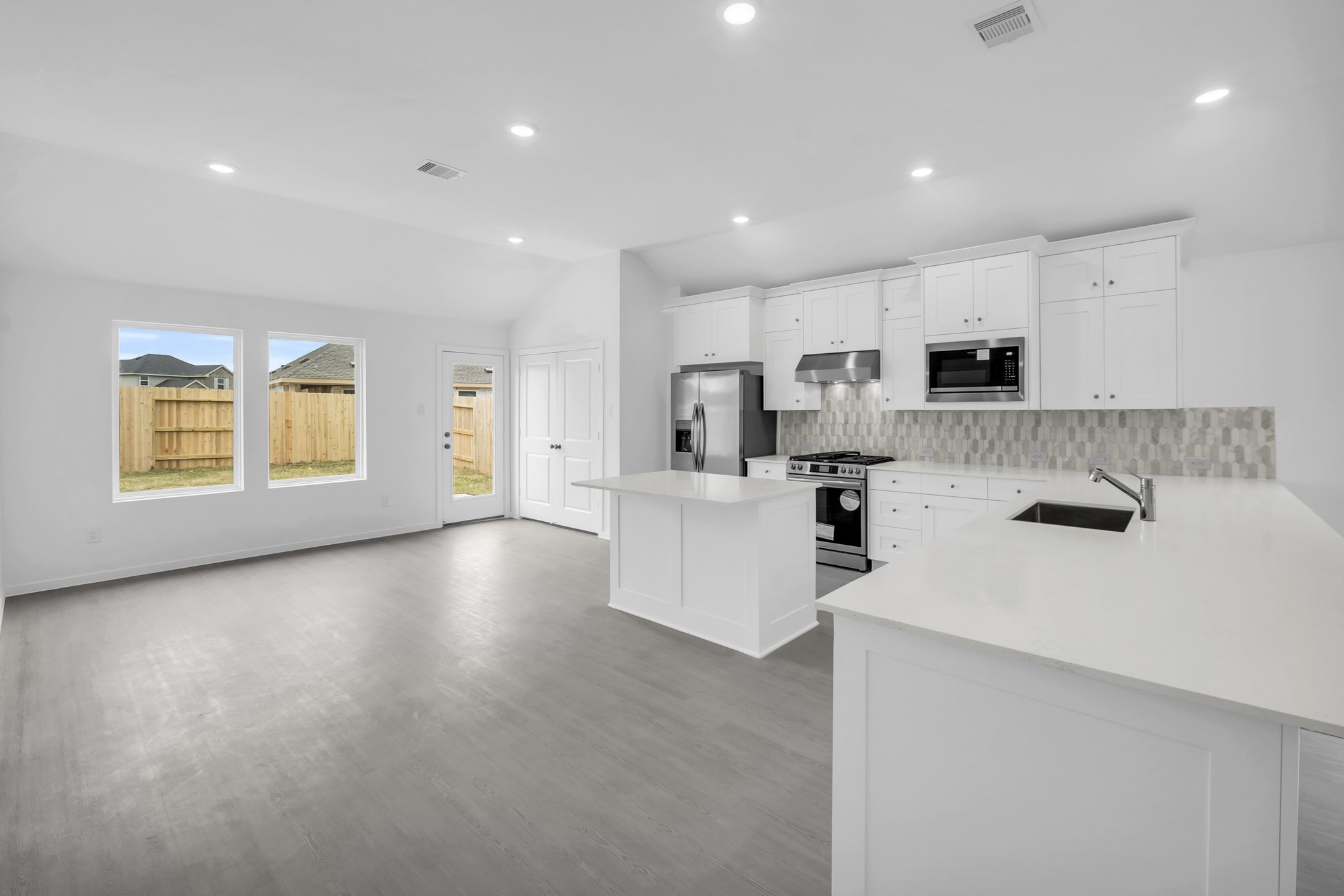 2131 Mosaic Vly Court Angleton, TX 77515 - Photo 8 of 29 a kitchen with stainless steel appliances a refrigerator sink and microwave