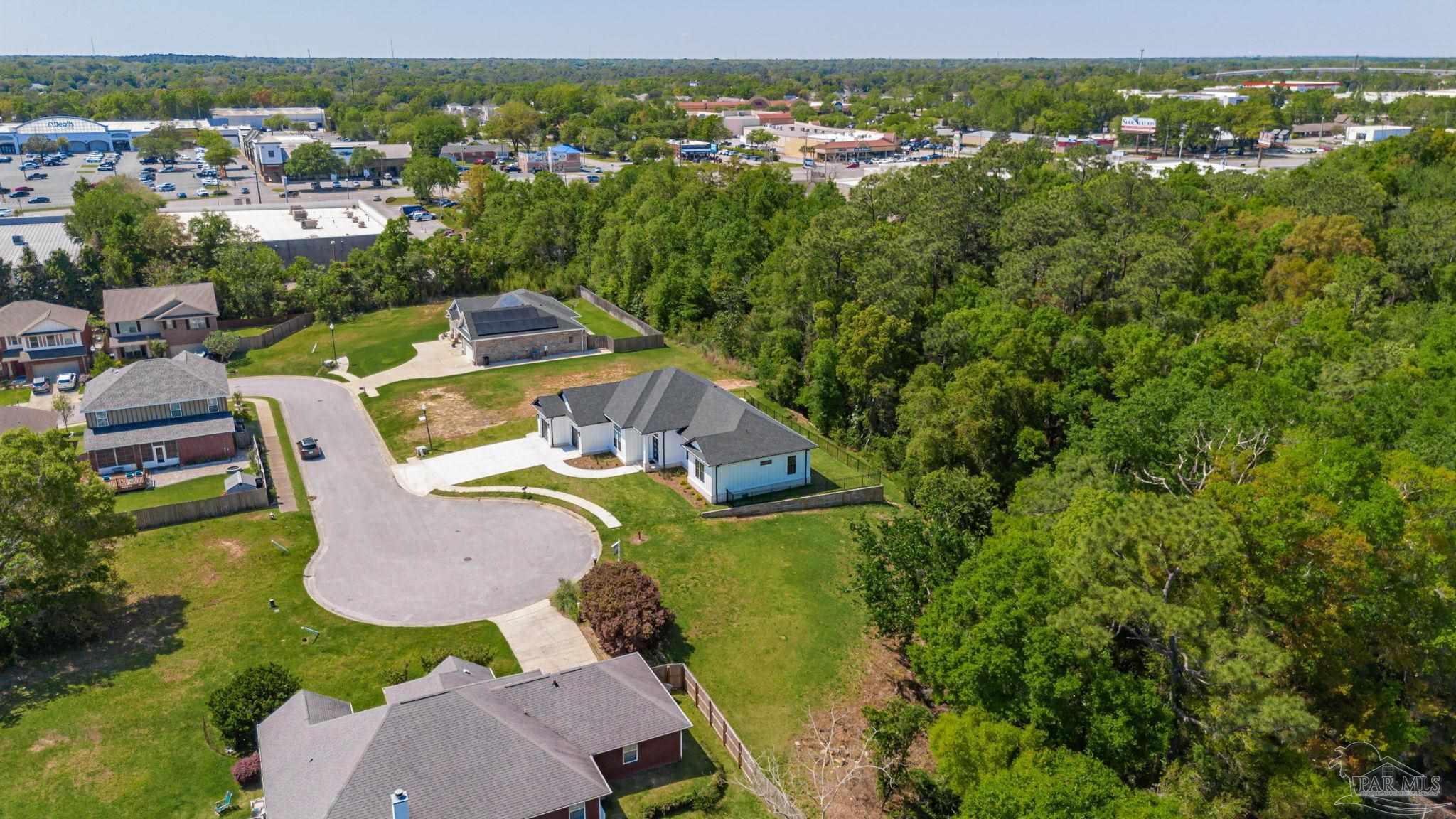 675 Farmington Road Pensacola, FL 32504 - Photo 4 of 19 an aerial view of a house with garden space and outdoor seating