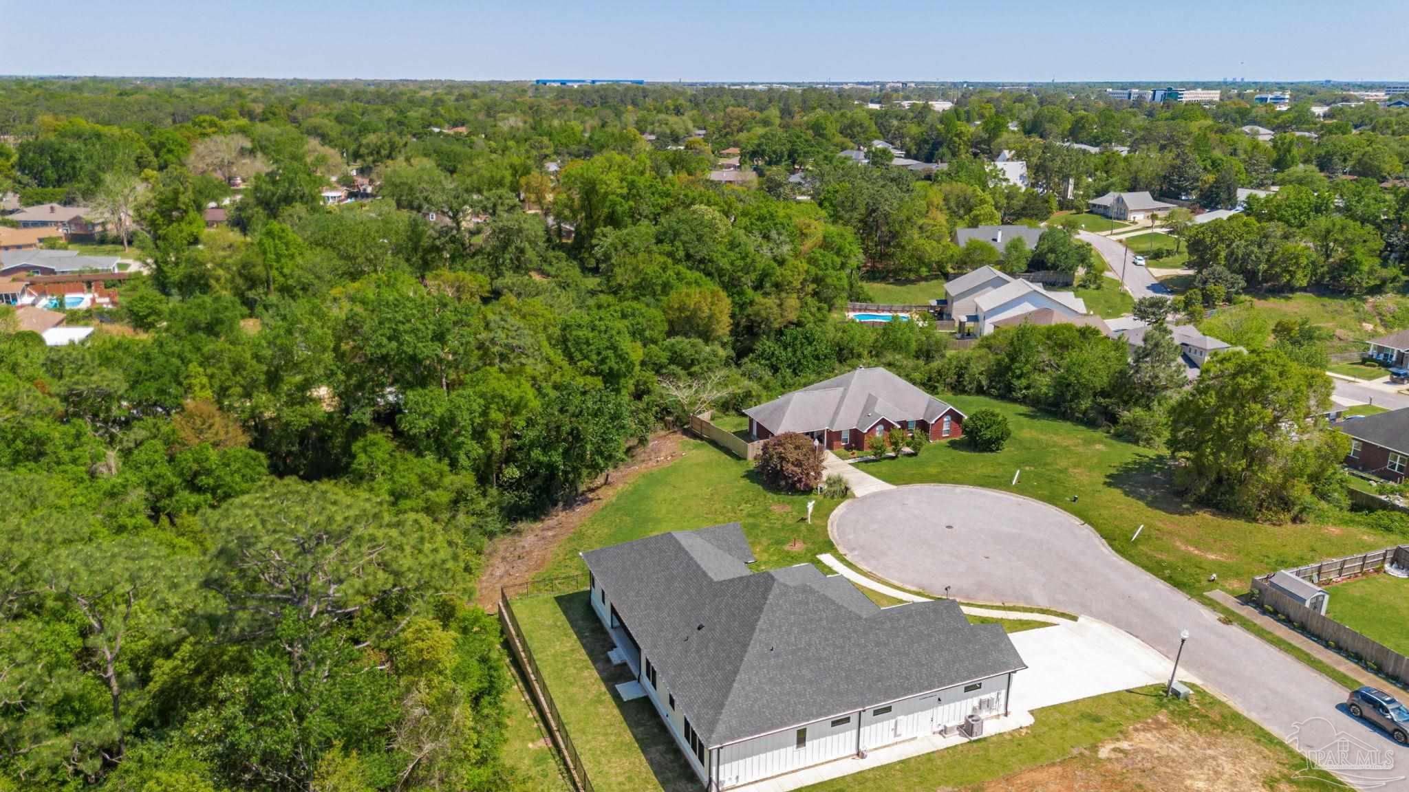 675 Farmington Road Pensacola, FL 32504 - Photo 8 of 19 an aerial view of a house with swimming pool garden and lake view