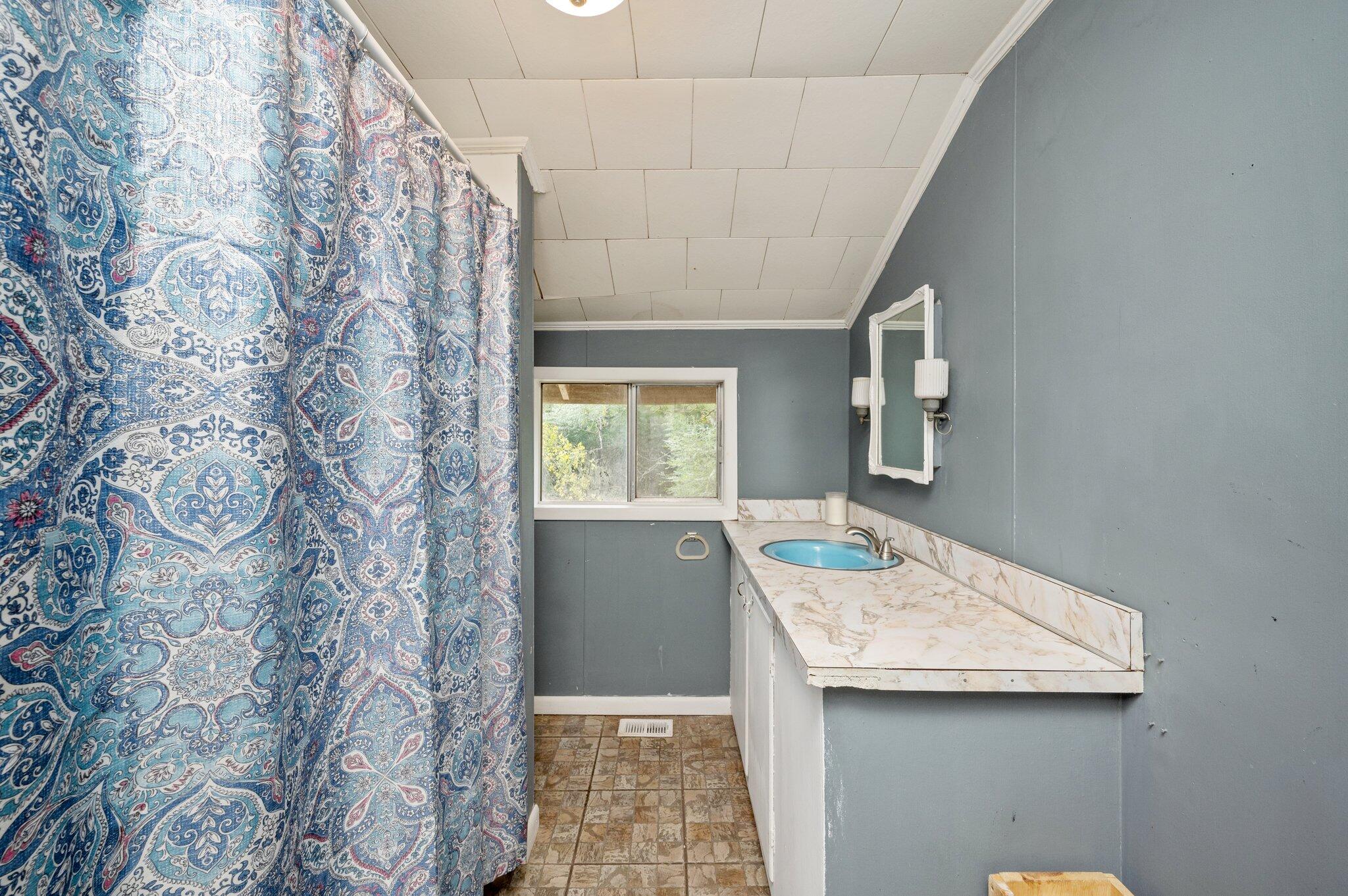 1390 Baker Manning Loop Ponce de Leon, FL 32455 - Photo 22 of 49 a bathroom with a granite countertop sink and a mirror
