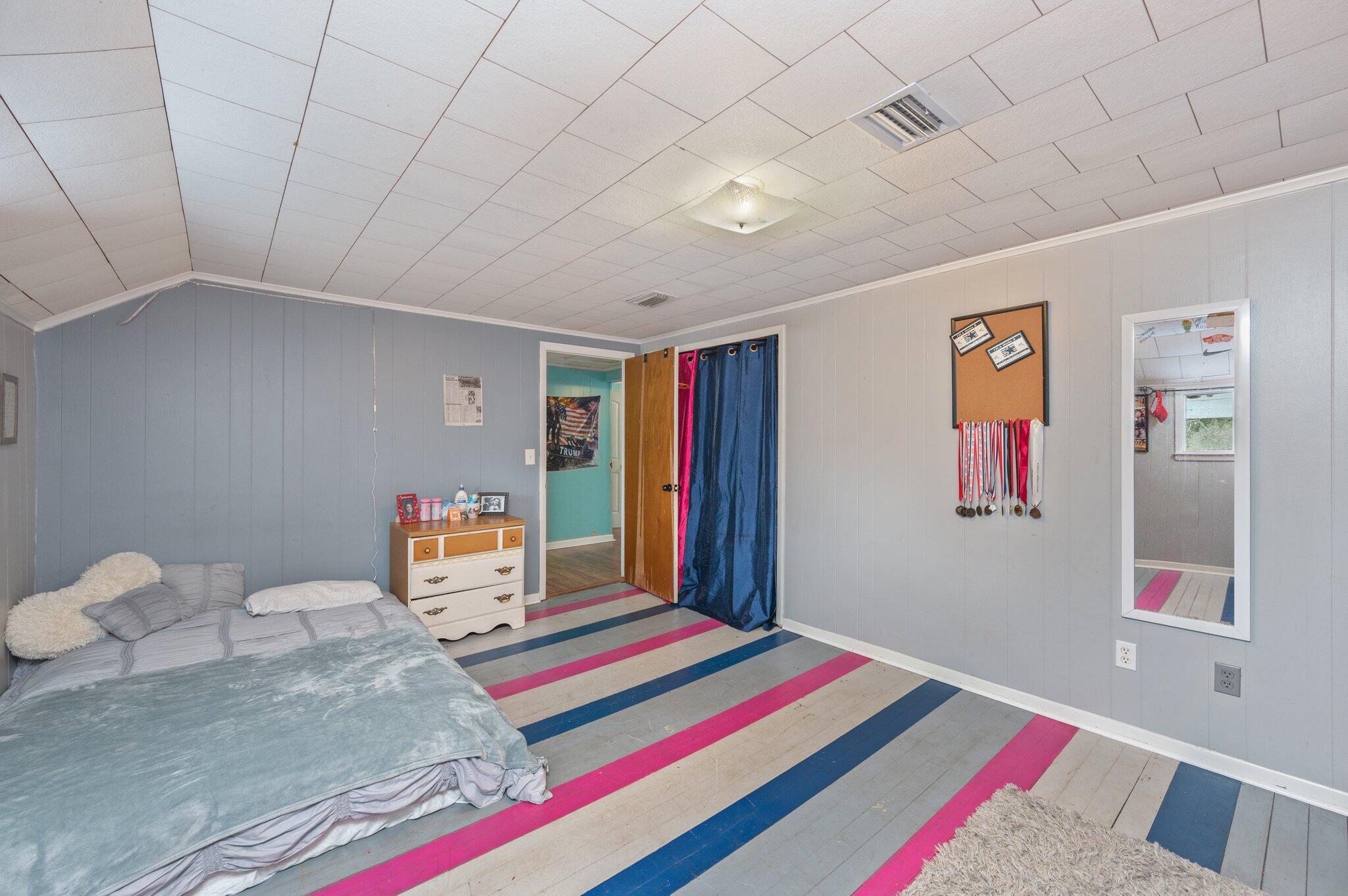 1390 Baker Manning Loop Ponce de Leon, FL 32455 - Photo 28 of 49 a bedroom with a bed and a bookshelf