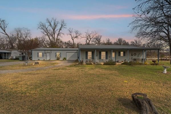 4861 E Highway Springtown, TX 76082 - Photo 15 of 29 a front view of a house with a yard table and chairs