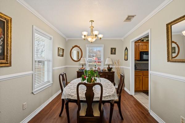 4861 E Highway Springtown, TX 76082 - Photo 17 of 29 a dining room with furniture a chandelier and wooden floor
