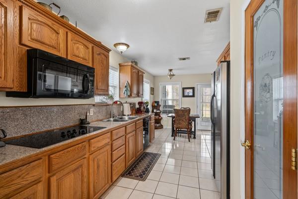 4861 E Highway Springtown, TX 76082 - Photo 18 of 29 a kitchen with stainless steel appliances granite countertop a sink and cabinets