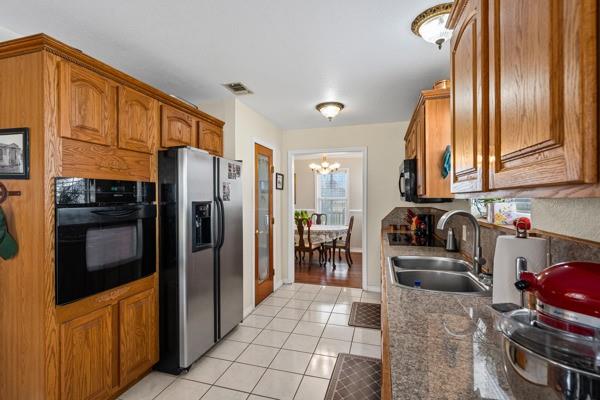 4861 E Highway Springtown, TX 76082 - Photo 20 of 29 a kitchen with granite countertop a refrigerator and a stove top oven