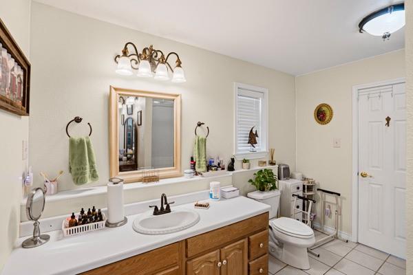 4861 E Highway Springtown, TX 76082 - Photo 25 of 29 a bathroom with a sink mirror and toilet