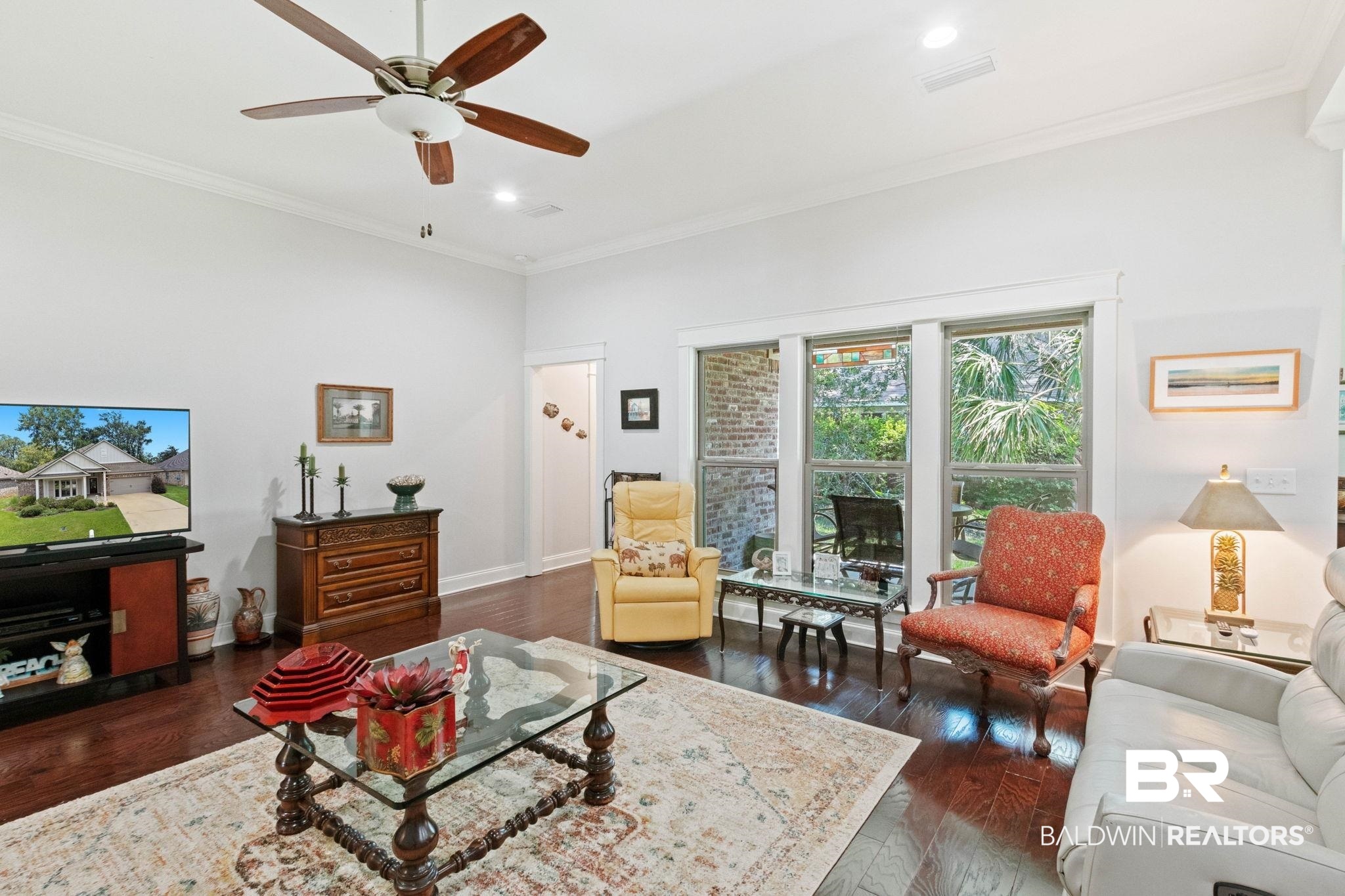 192 Mark Twain Loop Foley, AL 36535 - Photo 5 of 42 Living room with ceiling fan, crown molding, and dark hardwood / wood-style flooring
