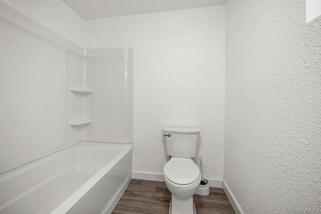 a bathroom with a toilet and bathtub