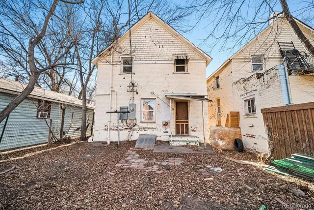 a view of a white house with large windows
