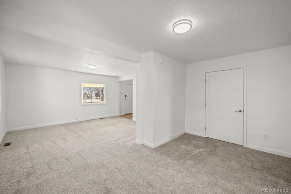 a view of an empty room and a window