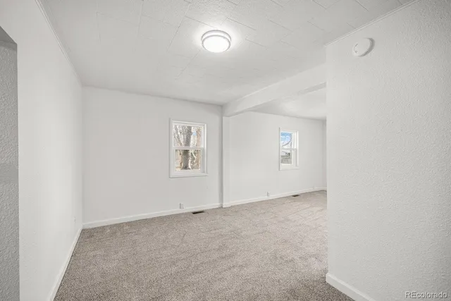 an empty room with a empty space and windows