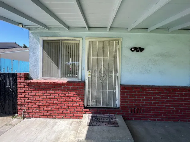 a view of a brick house with an outdoor space