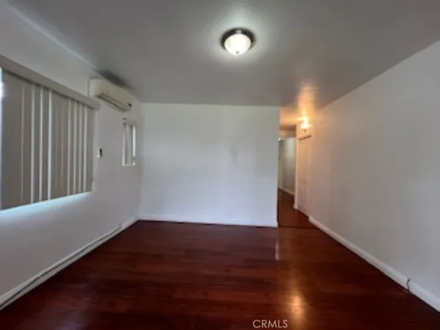 a view of a room with wooden floor