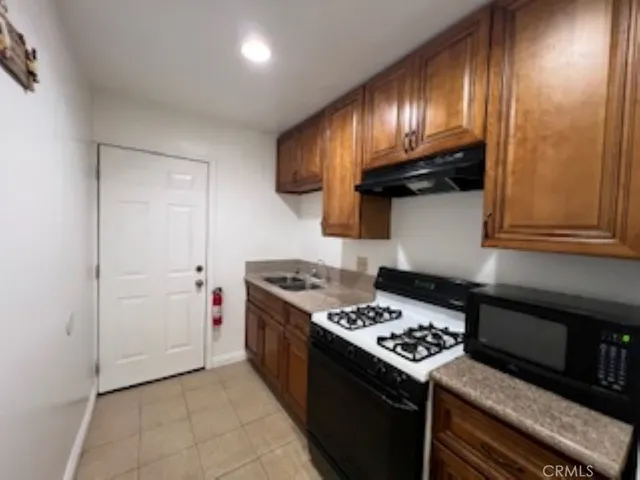 a kitchen with stainless steel appliances granite countertop a stove and a refrigerator