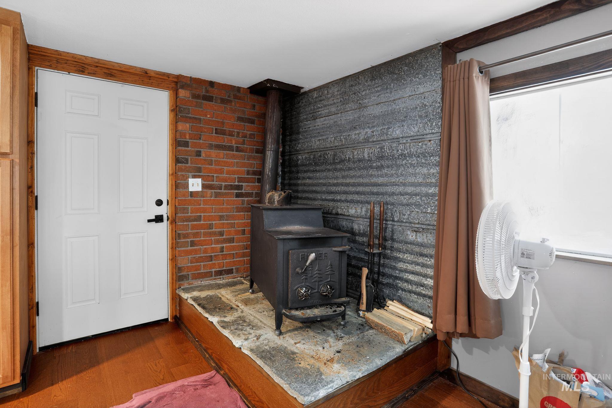 654 Bings Road Cascade, ID 83611 - Photo 14 of 45 Detailed view of wood finished floors and a wood stove