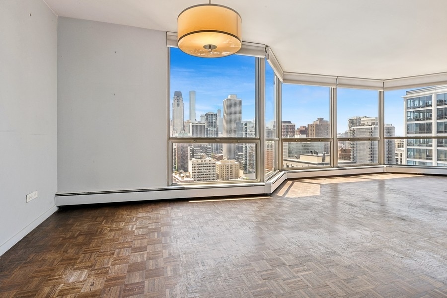 1310 North Ritchie Court, Unit 27B Chicago, IL 60610 - Photo 11 of 31 a view of an empty room with a window