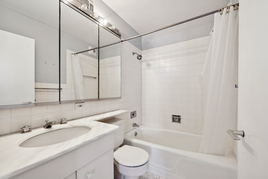 1310 North Ritchie Court, Unit 27B Chicago, IL 60610 - Photo 15 of 31 a bathroom with a sink toilet tub and shower