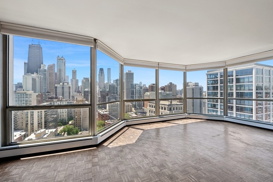 1310 North Ritchie Court, Unit 27B Chicago, IL 60610 - Photo 5 of 31 a view of a room with gym equipment and windows