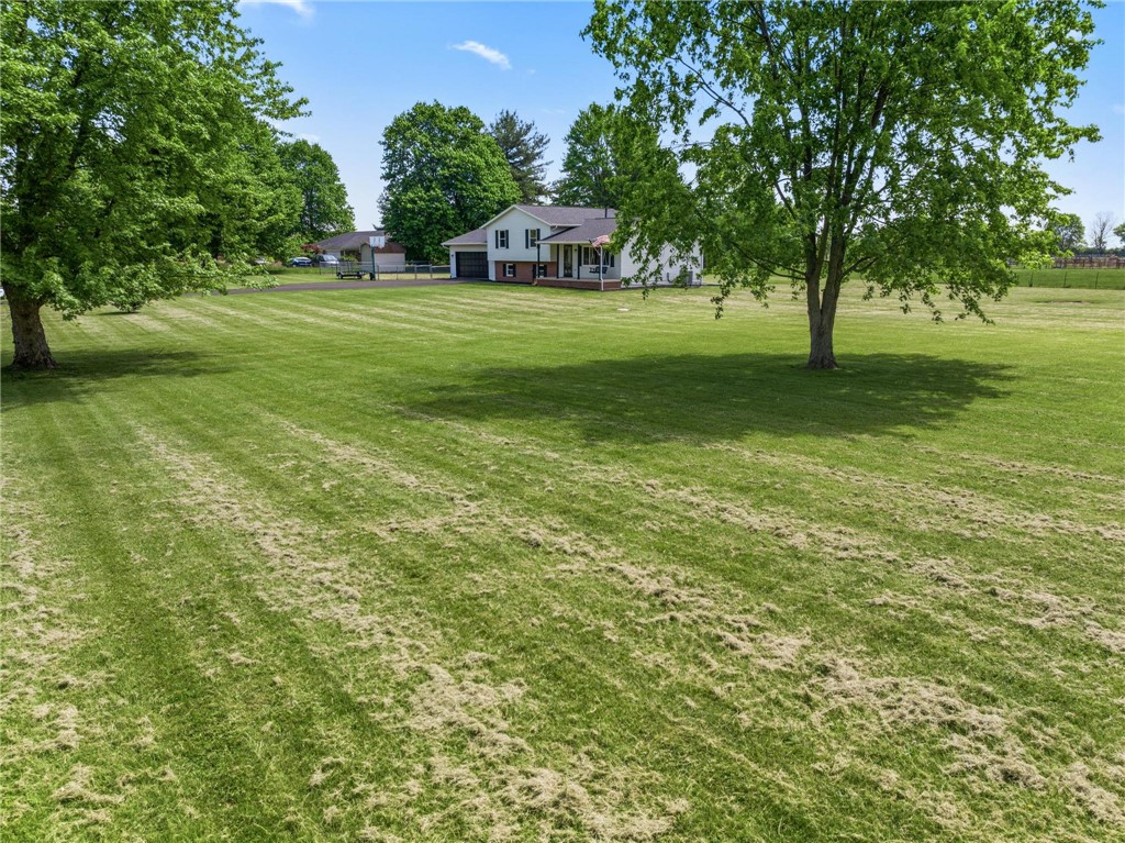 1353 Foust Road Xenia, OH 45385 - Photo 13 of 50 This expansive estate features a charming home nestled within a vast, verdant landscape.