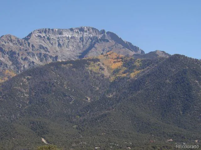 a view of a dry yard with mountains in the background