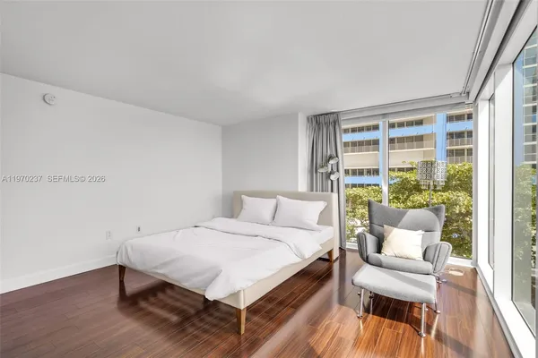 a bedroom with a bed and a couch