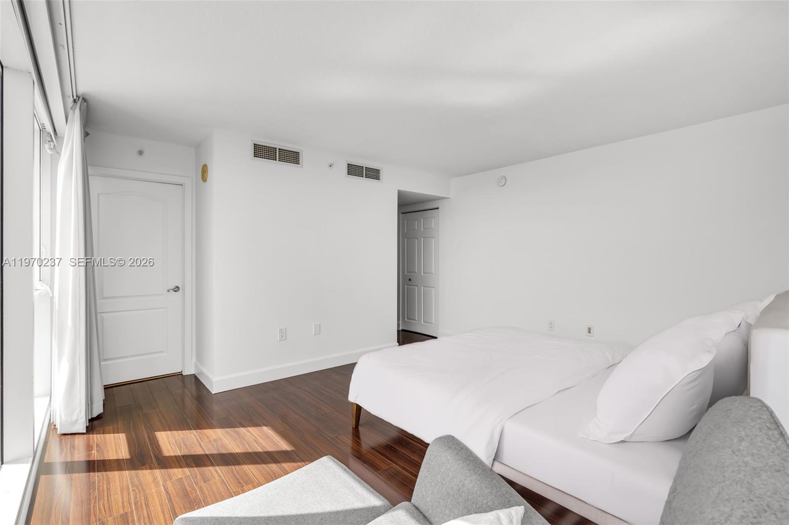 2101 Brickell Avenue, Unit 306 Miami, FL 33129 - Photo 13 of 49 a bed room with a bed and a rug