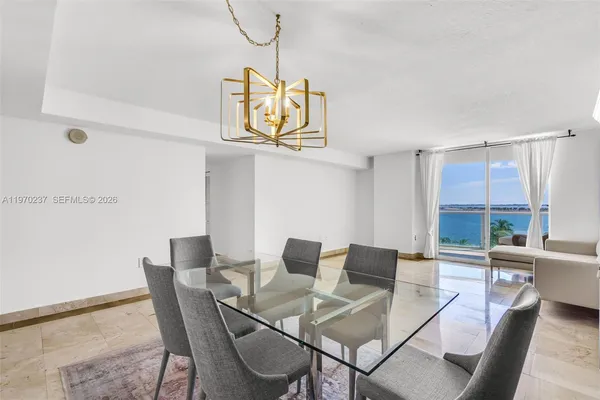 a living room with furniture and dining table