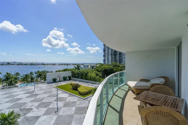 a view of a balcony with furniture