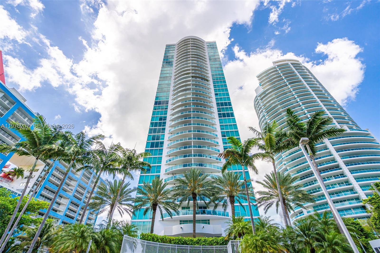 2101 Brickell Avenue, Unit 306 Miami, FL 33129 - Photo 42 of 49 a view of a tall building with a palm tree in the background