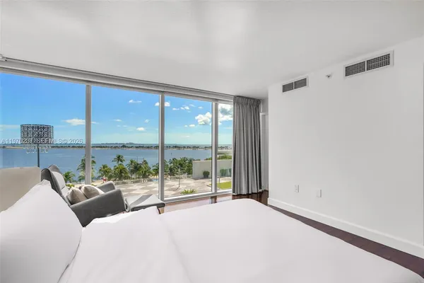a living room with furniture and a floor to ceiling window