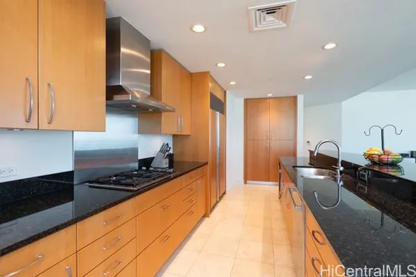 a kitchen with stainless steel appliances granite countertop a sink stove and cabinets