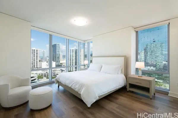 a bedroom with a bed and a couch next to a window