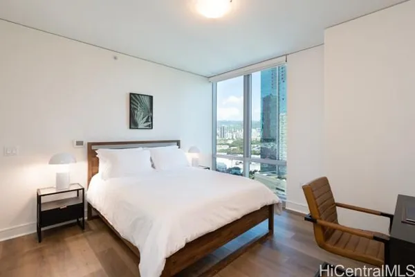 a large bed sitting in a bedroom next to a window