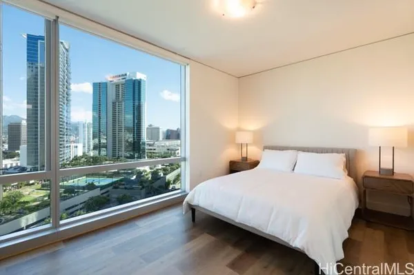 a bedroom with a large window and a bed