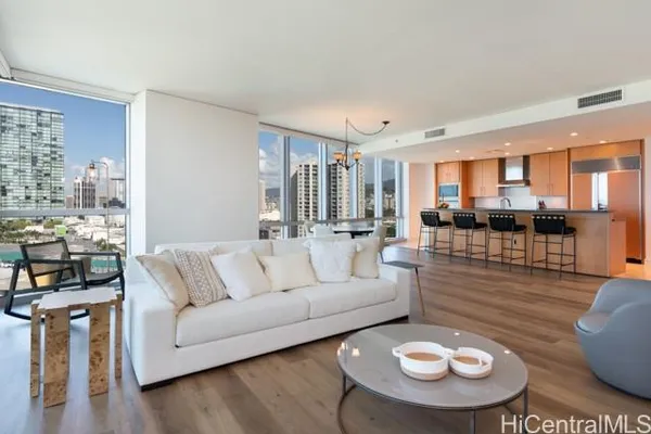 a living room with furniture and kitchen view