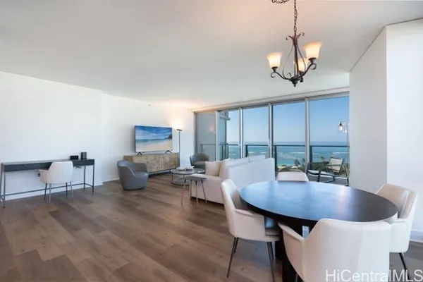 a view of a dining room with furniture wooden floor and chandelier