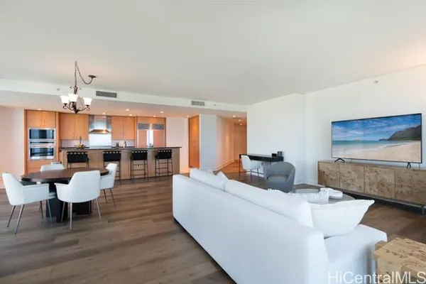 a living room with furniture and a wooden floor