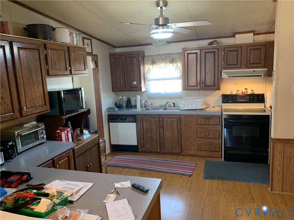 15532 Sandy Field Road Stony Creek, VA 23882 - Photo 10 of 20 a kitchen with stainless steel appliances kitchen island granite countertop a stove top oven a sink dishwasher and a fireplace with wooden floor