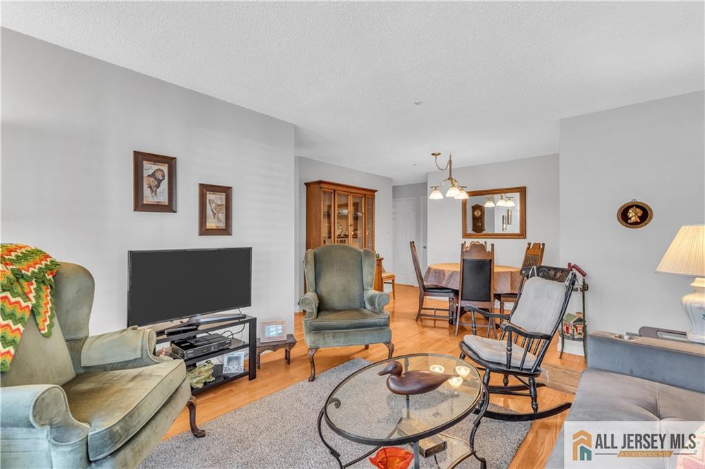1188 Richmond Road Mahwah, NJ 07430 - Photo 8 of 26 a living room with fireplace furniture and a flat screen tv