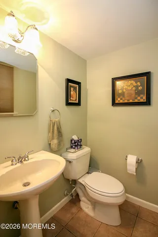 a bathroom with a toilet a sink and a mirror
