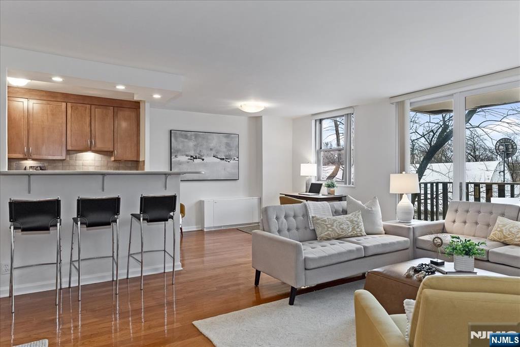 a living room with furniture kitchen and a table