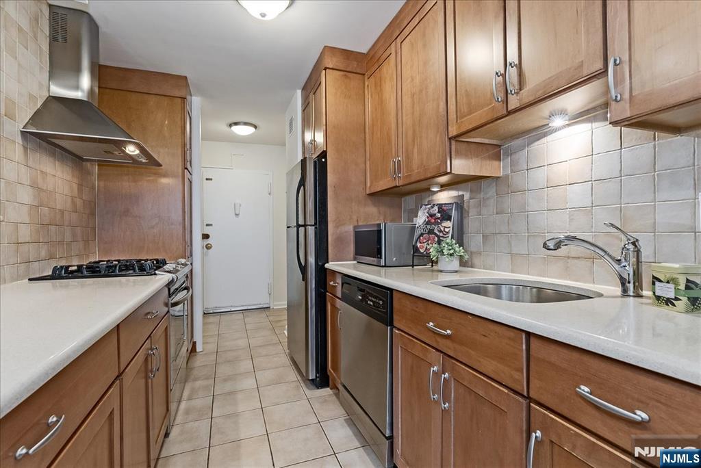 530 Valley Road, Unit C003L Montclair, NJ 07043 - Photo 12 of 25 a kitchen with a sink stove and cabinets
