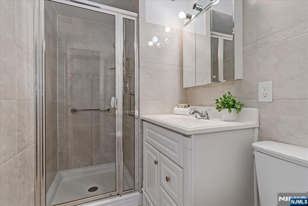 530 Valley Road, Unit C003L Montclair, NJ 07043 - Photo 17 of 25 a bathroom with a sink a toilet and shower