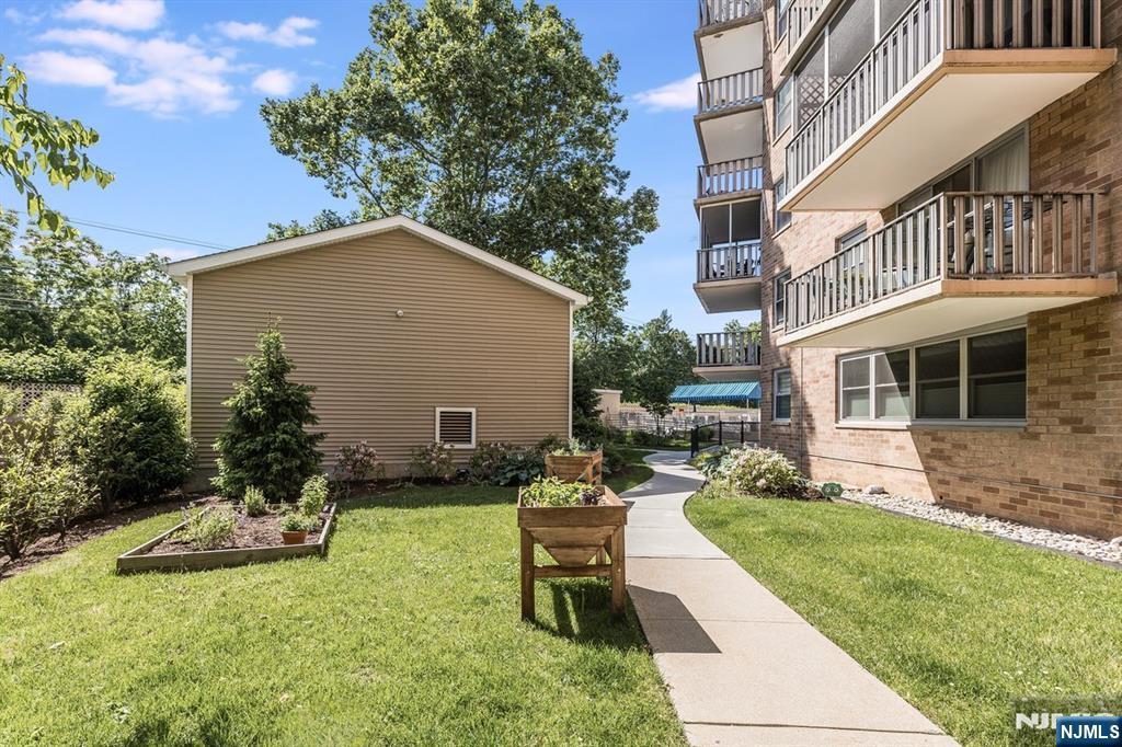 530 Valley Road, Unit C003L Montclair, NJ 07043 - Photo 24 of 25 a view of a house with backyard sitting area and garden