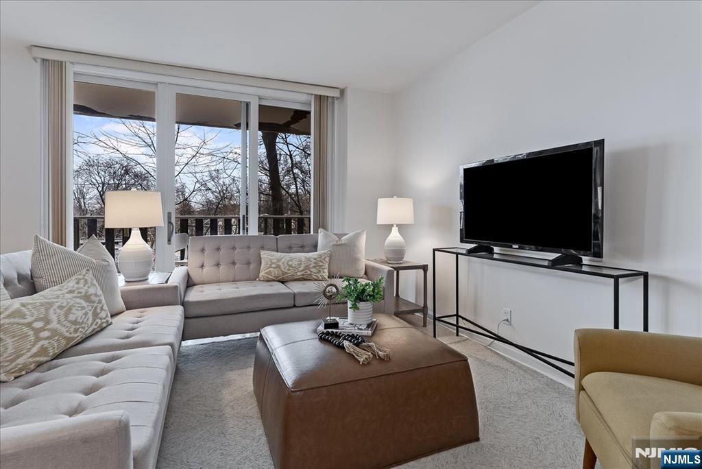 530 Valley Road, Unit C003L Montclair, NJ 07043 - Photo 4 of 25 a living room with furniture and a flat screen tv