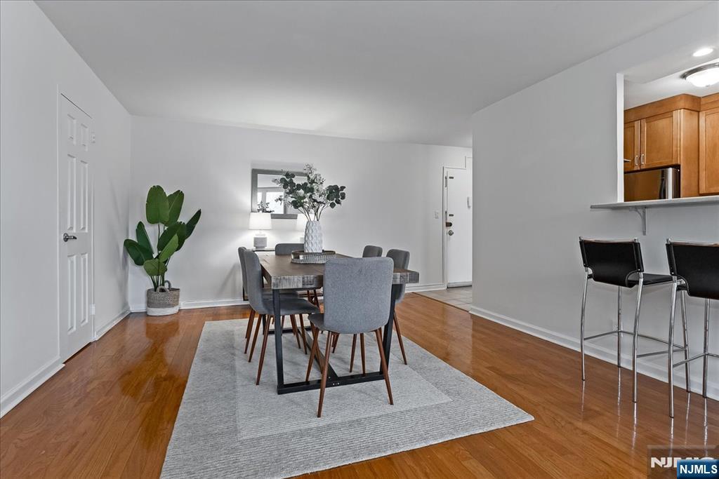 530 Valley Road, Unit C003L Montclair, NJ 07043 - Photo 9 of 25 a view of a dining room with furniture and wooden floor