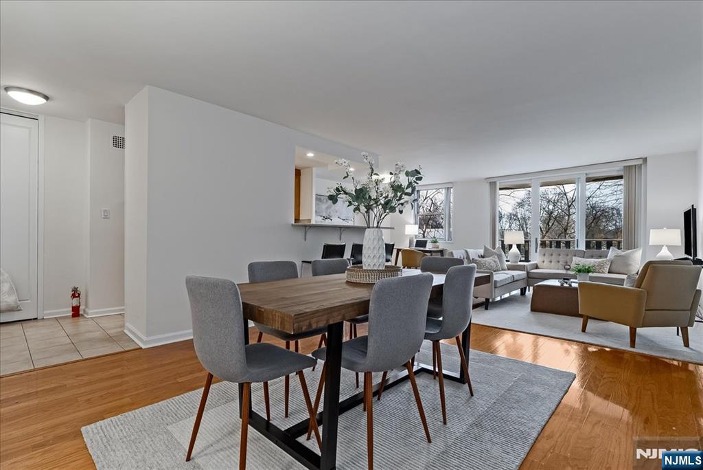 530 Valley Road, Unit C003L Montclair, NJ 07043 - Photo 10 of 25 a view of a dining room with furniture window and wooden floor