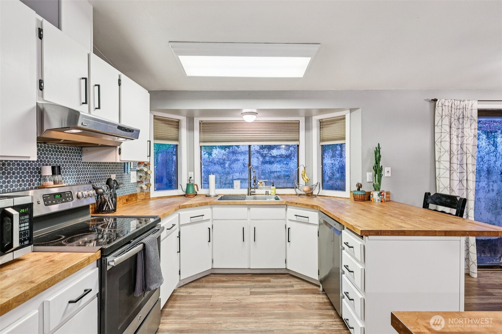 29 Maple Court Bellingham, WA 98229 - Photo 12 of 39 a kitchen with a sink stove and cabinets