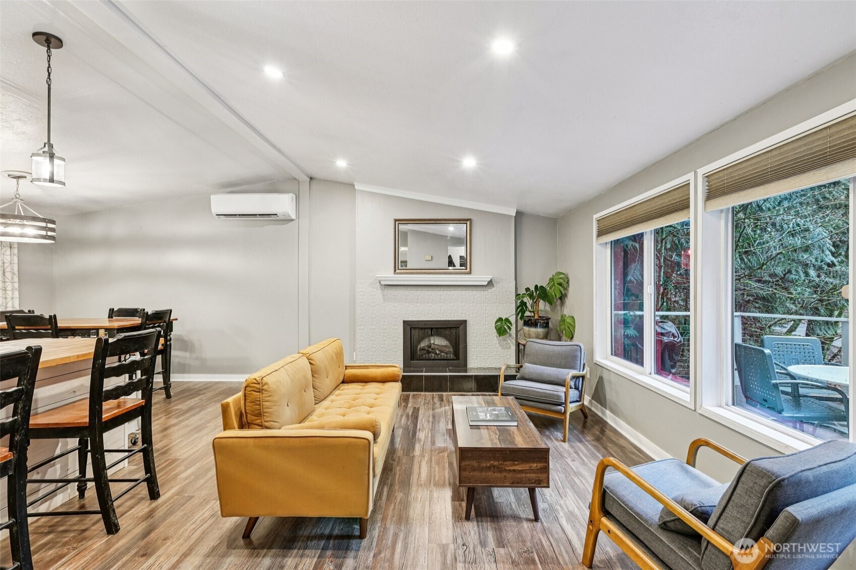29 Maple Court Bellingham, WA 98229 - Photo 9 of 39 a living room with furniture a fireplace and a floor to ceiling window